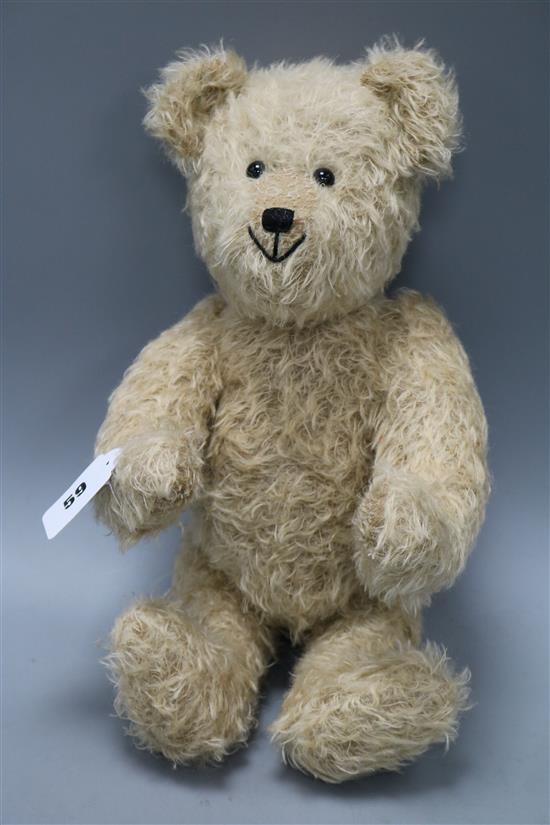 A blonde plush Teddy bear with hump and growler
